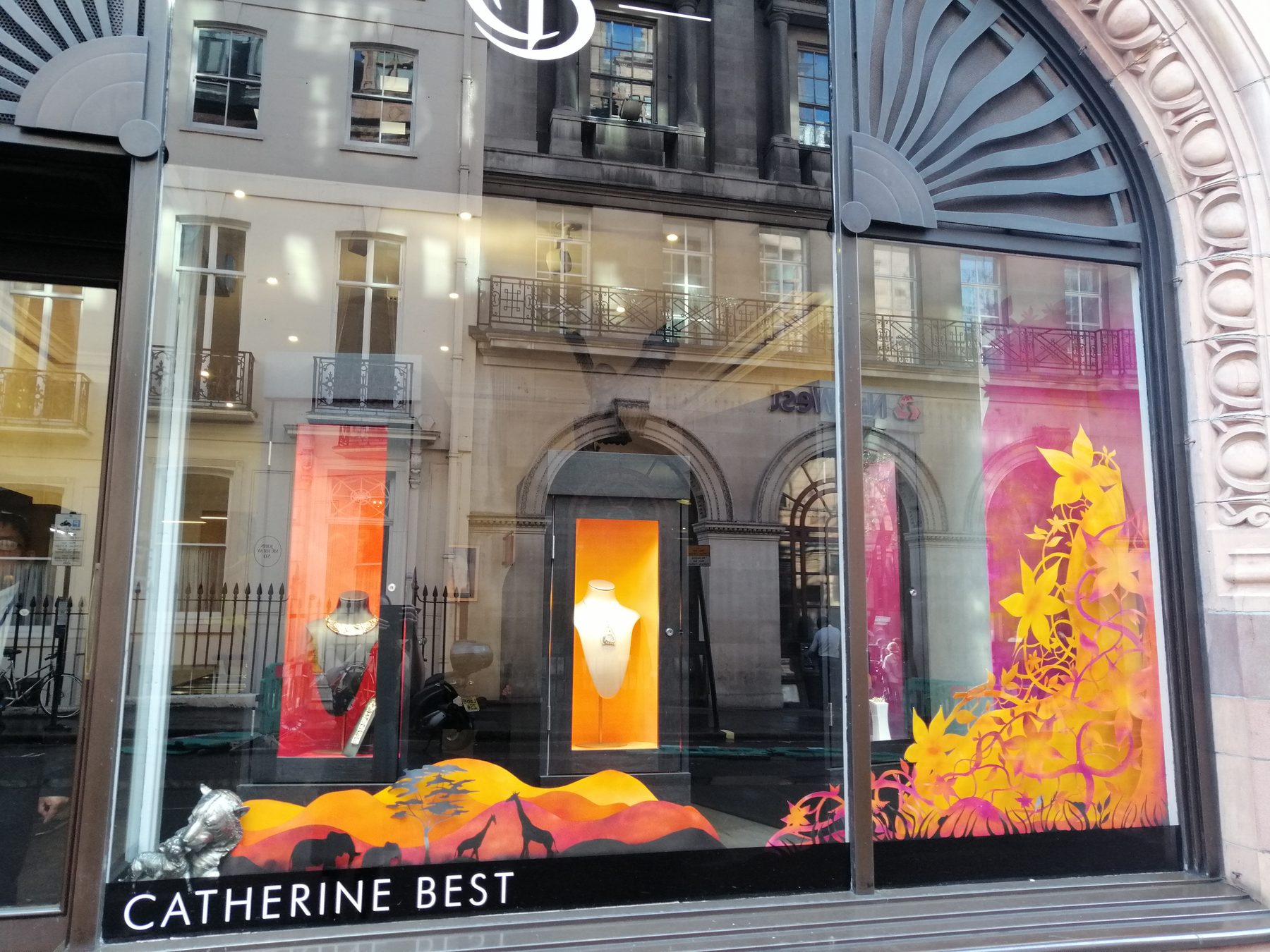 The full summer window: a savannah at sunset along the base and a climbing column of flowers up the right